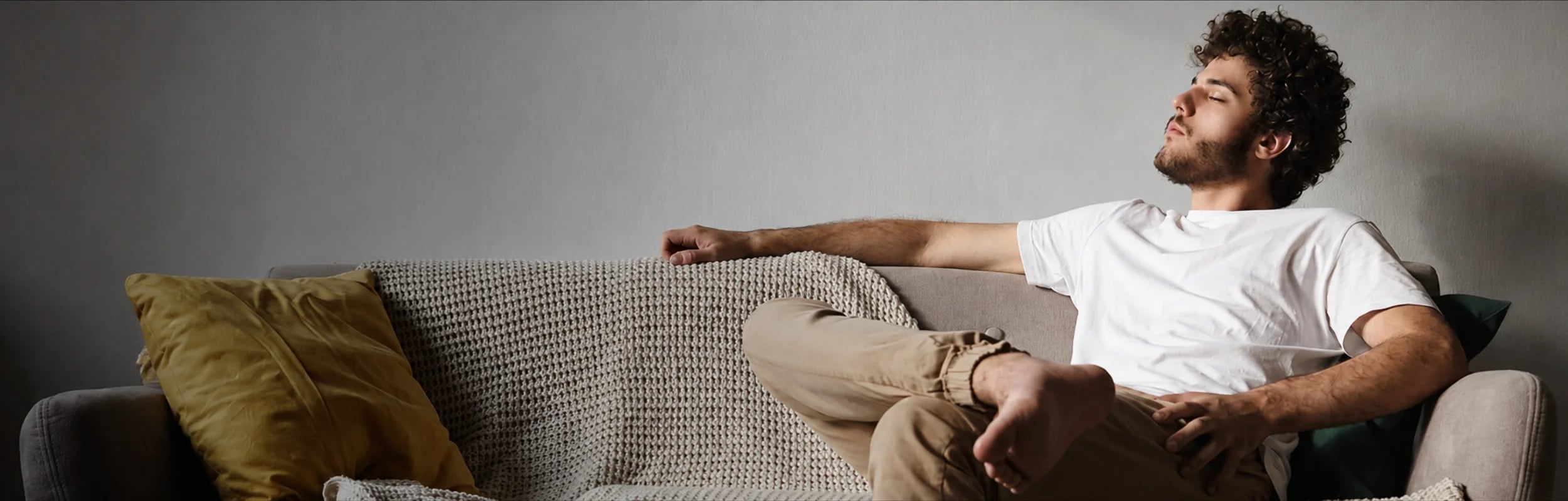 A man relaxing on the couch of a vacation rental home